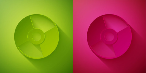 Paper cut CD or DVD disk icon isolated on green and pink background. Compact disc sign. Paper art style. Vector Illustration