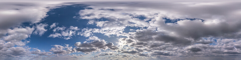 Seamless hdri panorama 360 degrees angle view blue sky with beautiful evening fluffy cumulus clouds without ground for use in 3d graphics or game development as sky dome or edit drone shot