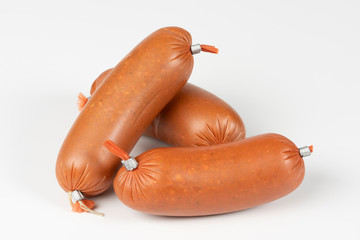 Smoked sausage in plastic shell isolated on white background. Top view