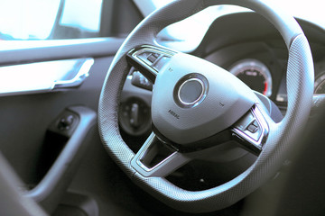Steering and instrument panel in the car close-up.  Left-hand drive. 
The latest technology and brand cars.
Driving and transportation concept.