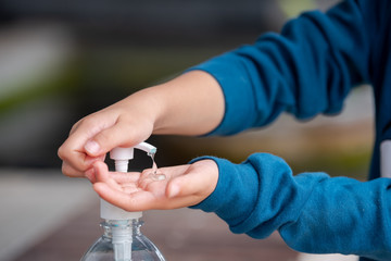 Child Using Hand Sanitizer.