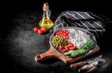 Appetizing healthy rice with vegetables on dark background. Healthy eating