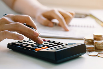 Young woman calculating monthly home expenses, taxes, bank account balance and credit card bills payment.income tax for pay taxes