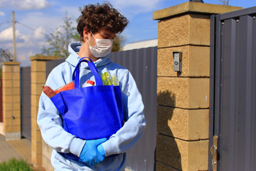 Young guy with a bag of products in his hands