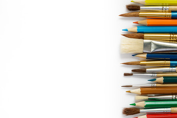 background of paint brushes and pencils for drawing