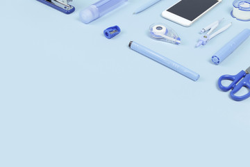 Assorted office and school white and blue stationery on pastel background as corner border. Flat...