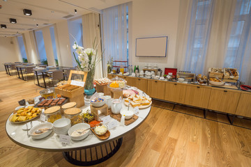 Breakfast served on round buffet table in hotel restaurant
