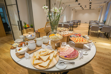 Breakfast served on round buffet table in hotel restaurant