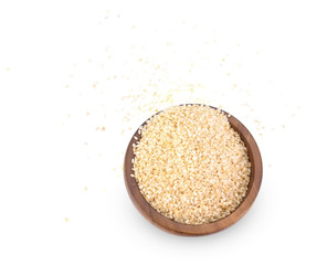 White sesame seeds in a wooden bowl on a white background