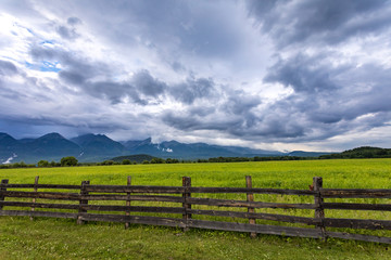 wooden fence in the valley with mountains, Arshan, Tunka valley