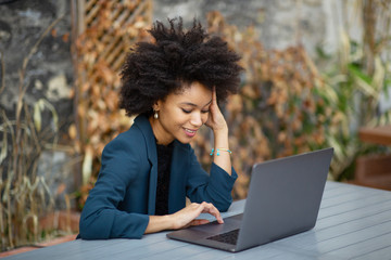 smiling african american businesswoman using laptop computer