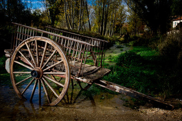 Fototapeta na wymiar old wooden cart in a river
