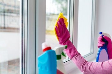 Woman cleaning a window with yellow cloth