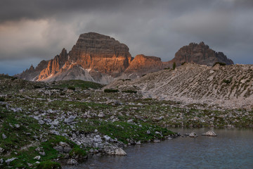 Mountain landscape in the European Dolomite Alps underneath the Three Peaks with alpenglow and lake...