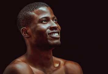 Black african man smile studio in beautiful style on black background. Black background. Isolated...