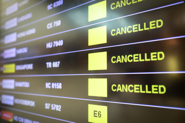 Flights cancelled and delayed on airport departure board due to covid-19 pandemic. Coronavirus...