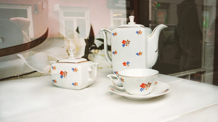 Beautiful vintage set of dishes in a display case
