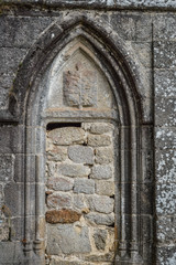 Ancient blocked door at the fortified monastery of Saint-Michel des Anges at Saint-Angel, France.