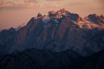 Mountain landscape in the European Dolomite Alps at the Three Peaks with alpenglow during sunset,...