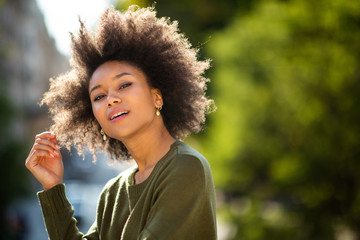 Close up beautiful young african american woman posing outside