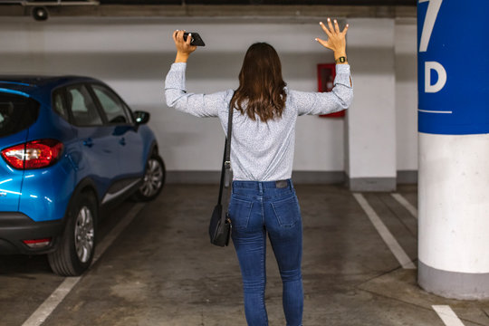 Young woman's car was stolen, can't find car at underground parking. Woman returned after shopping and didn't find her car on underground parking. - Powered by Adobe