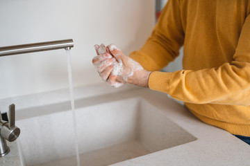 Washing hands with antibacterial gel man for corona virus prevention, hygiene