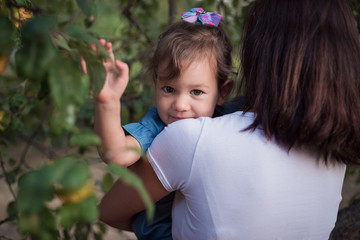 Moms holding her baby. Baby portrait on moms hands. Beautiful girl with caria eyes.