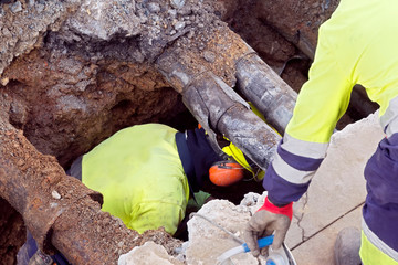 sewer  utility worker for cleaning and repairing sewerage pipes  in construction site