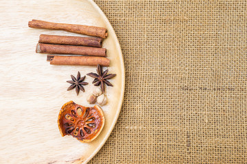 Dry spice on wooden tray with space on hessian fabric background, Thai herbs, aroma spice, healthy food