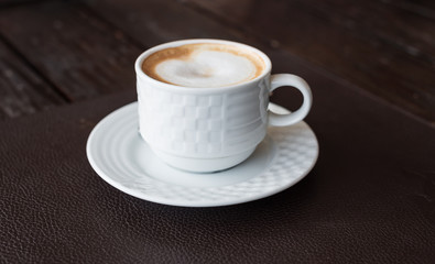 White stylish cup with fragrant drink. Coffee with milk