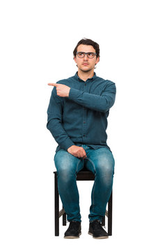 Full length of fink guy informer pointing index finger aside, blaming someone as guilty or choosing something, isolated on white background. Frustrated nerd, business worker snitch wears glasses.