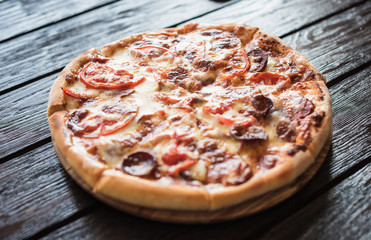 Big tasty sausage and tomatoes pizza.