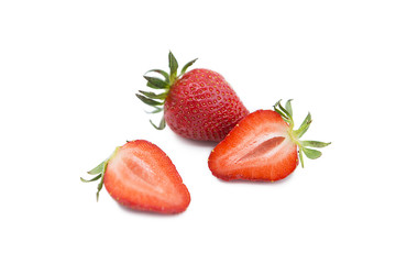 Ripe fresh organic strawberry and two halves of a strawberry with leaves isolated on white...
