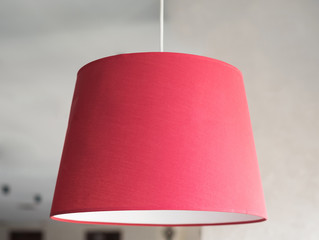 Stylish red lamp in an interior.