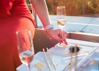 The girl in a red dress with a glass of champagne