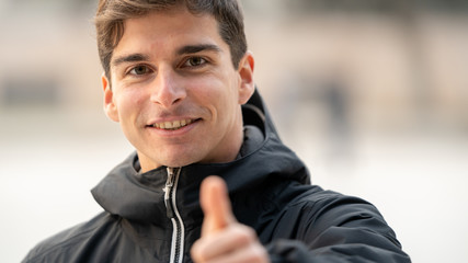 smiling man making ok gesture with his hand