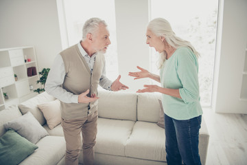 Obraz premium Side profile photo of nervous negative in bad mood woman shouting on shocked annoyed man