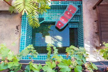 Fototapeta na wymiar Spa pool with dirty water from the roof, garden design, pool problem house without gutter, beautiful spa pool design, dirty pool