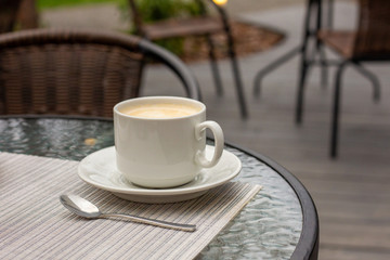 Mug of coffee in a summer cafe. Luxury rest.