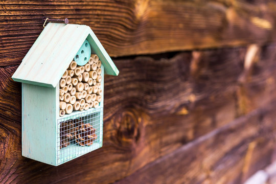 Rustic shelter for mason bees - DIY hive (bee house) made of natural materials, traditional design. Symbol of eco friendly beekeeping