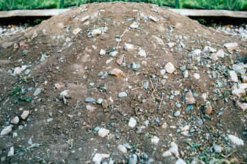 Earth pile on the edge of a walkway