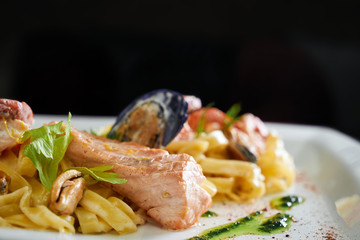 Close up of pasta with seafood and sauce.