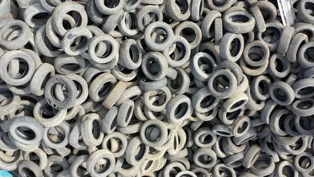 Aerial drone video of old abandoned car tires. Pollution and ecology concept