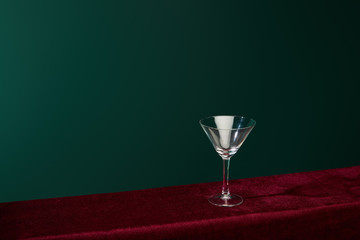 high angle view of empty cocktail glass isolated on green