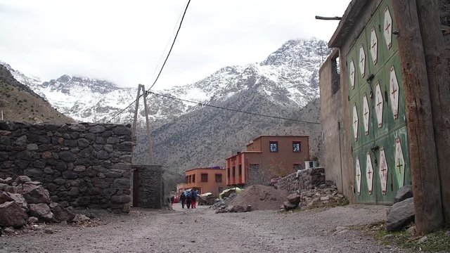 Small village with snowy mountains at winter at Aroumd village, in the Moroccan Atlas.
High angle, traveling movement, slow motion, HD.