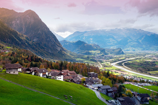 Scenic aerial view of hillside villages in Triesenberg and the river Rhine, natural border of Liechtenstein, an alpine country in central Europe, to Switzerland