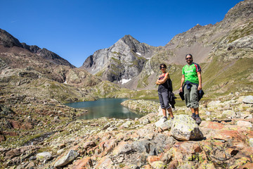 Fototapeta premium A couple of mountaineers on the Ibon de Panticosa trek in the Pyrenees, Aragon. Spain