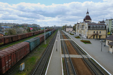 Railway station in Lutsk Ukraine. Deserted area and station building. Freight cars. Morning industrial landscape. Top view. 