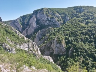 Fototapeta na wymiar green rocky mountains in spring season on sunny day
