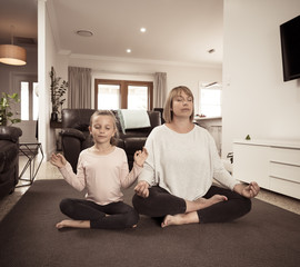 COVID-19 Outrbreak. Family doing yoga together at home during coronavirus quarantine